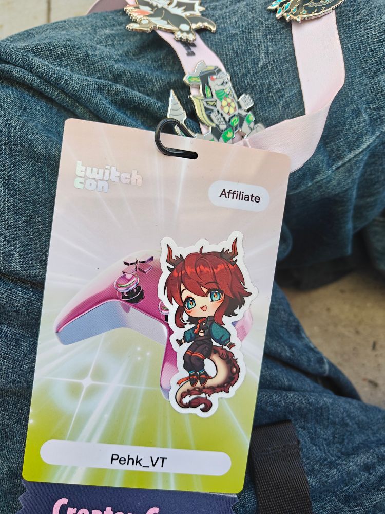 A photo of a twitchcom badge with a sticker and the name "pehk vt" on it 