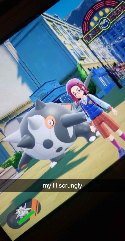 a photo of a game of Pokemon Scarlet. Its willows character, followed by the shiny pokemon cetitan 