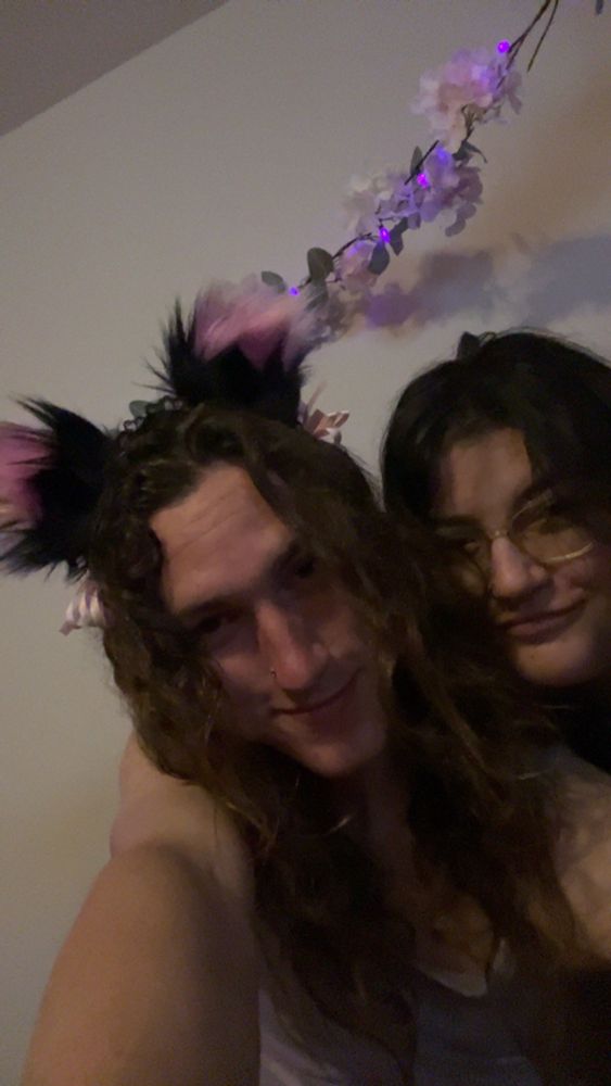 Photo of my wife and I, I’m wearing fluffy cat ears and he is to my left