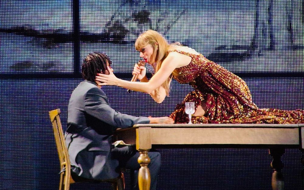A photo of Taylor Swift wearing the bronze evermore dress during “tolerate it”