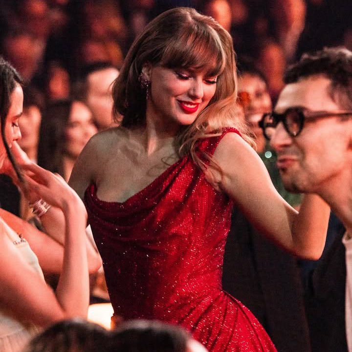 A photo of Taylor Swift from the 2025 Grammys dancing in the crowd and smiling