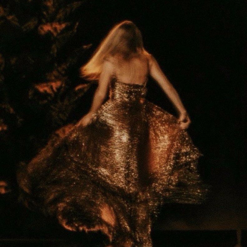 A photo of Taylor Swift wearing the bronze evermore dress 