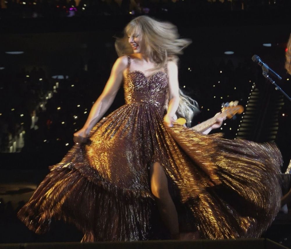 A photo of Taylor Swift wearing the bronze evermore dress 