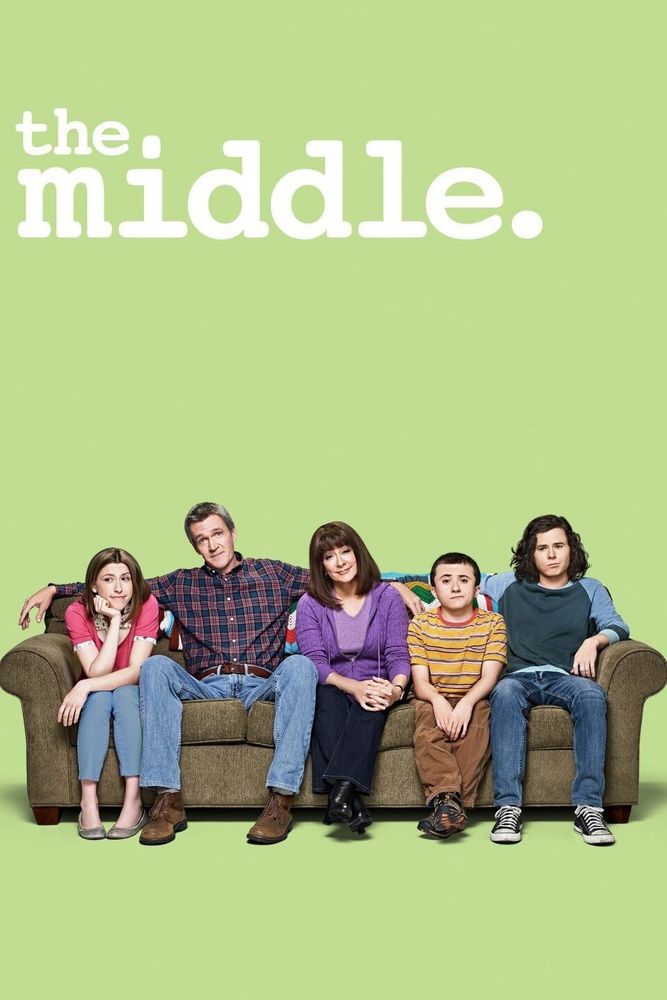 The cast of the TV series THE MIDDLE, sitting on a sofa. 