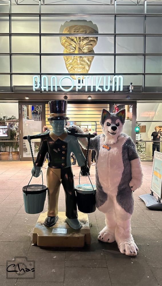 fursuiter standing next to a water carrier statue in front of the Panoptikum (wax museum) at Hamburg Reeperbahn