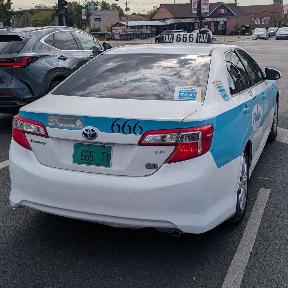 A taxi with badge number "666"
