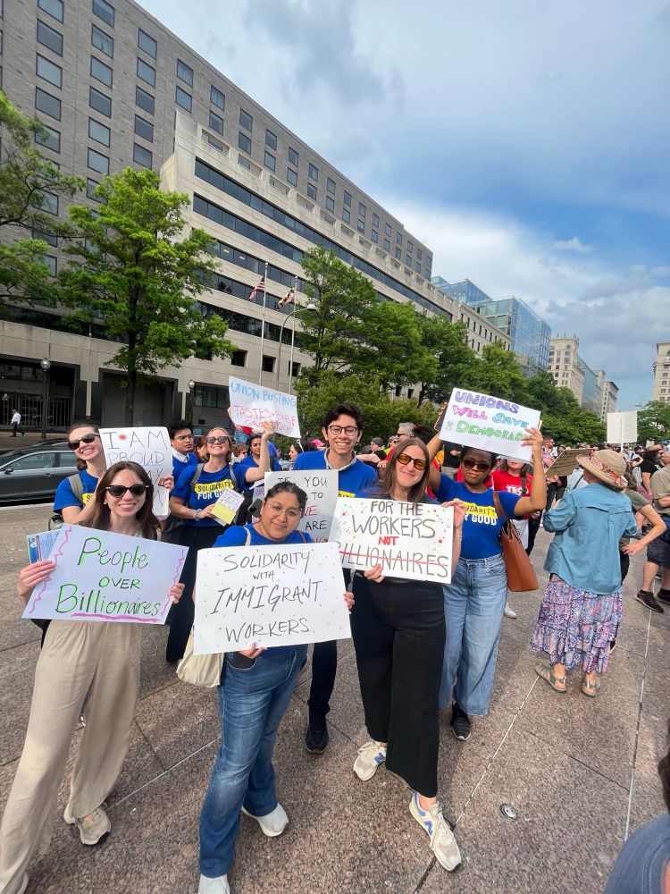 CAP Union members standing in solidarity holding multiple signs for May Day 