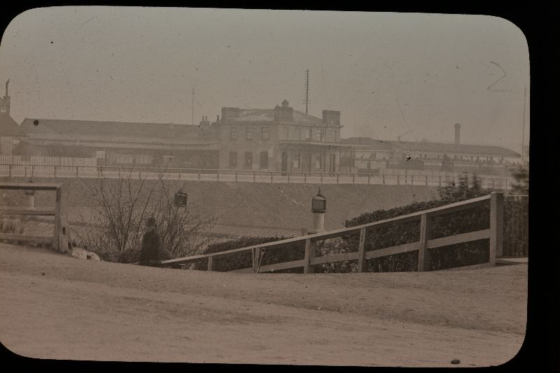 photograph of Reading station from the early 1860s, showing station buildings in the background and a road in the foreground. From Reading Museum's collection