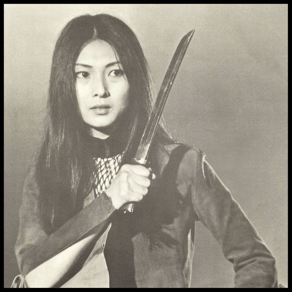 Black and white image of Meiko holding a short sword up in front of her.