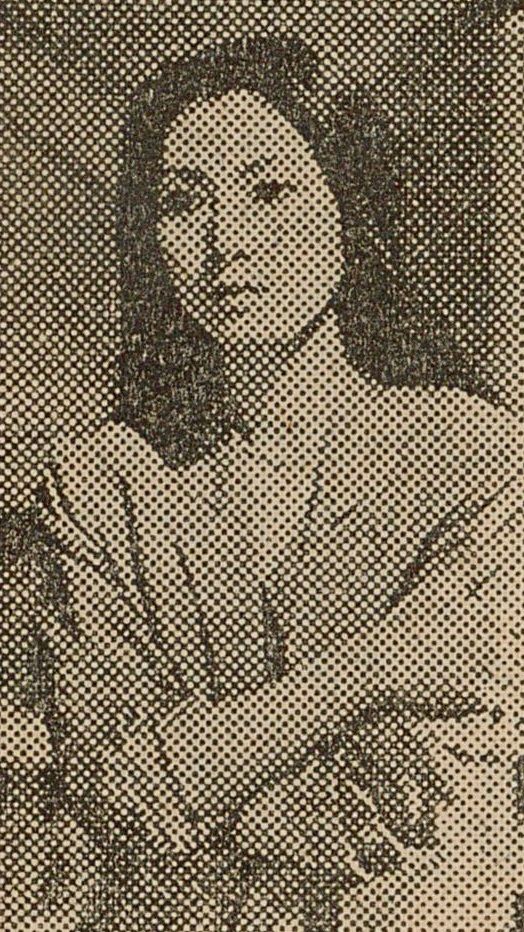 Black and white newsprint image of Meiko crossing her arms