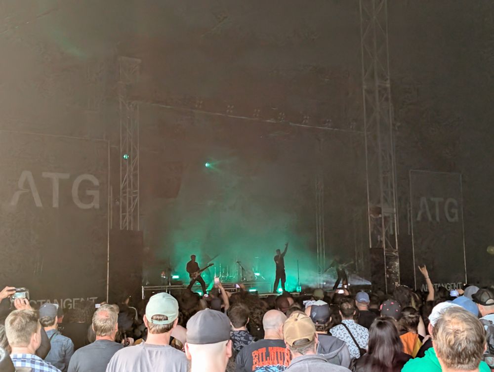 Band playing on stage with cool green lights 