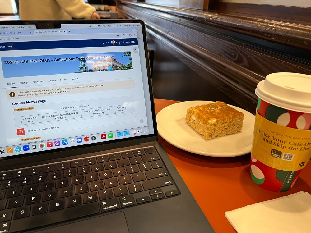 A laptop, player with marshmallow bar and a coffee. 