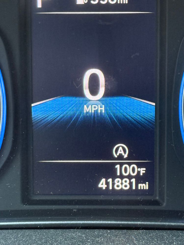 Speedometer listing temperature of 100 degrees. 