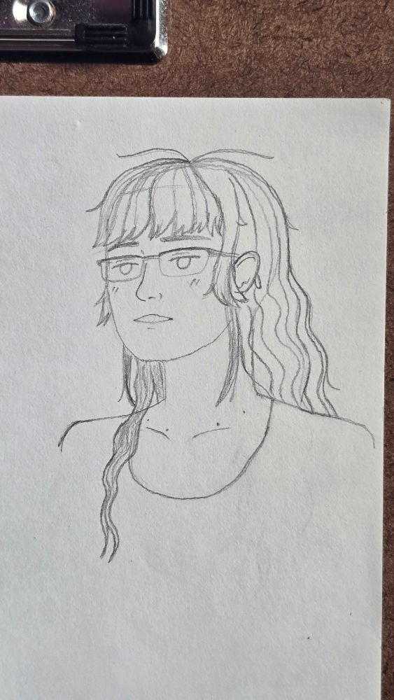 Pencil sketch portrait of myself on a piece of sketchbook paper on a clipboard