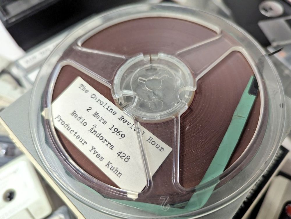 Spool of audio tape labelled "Caroline revival hour".