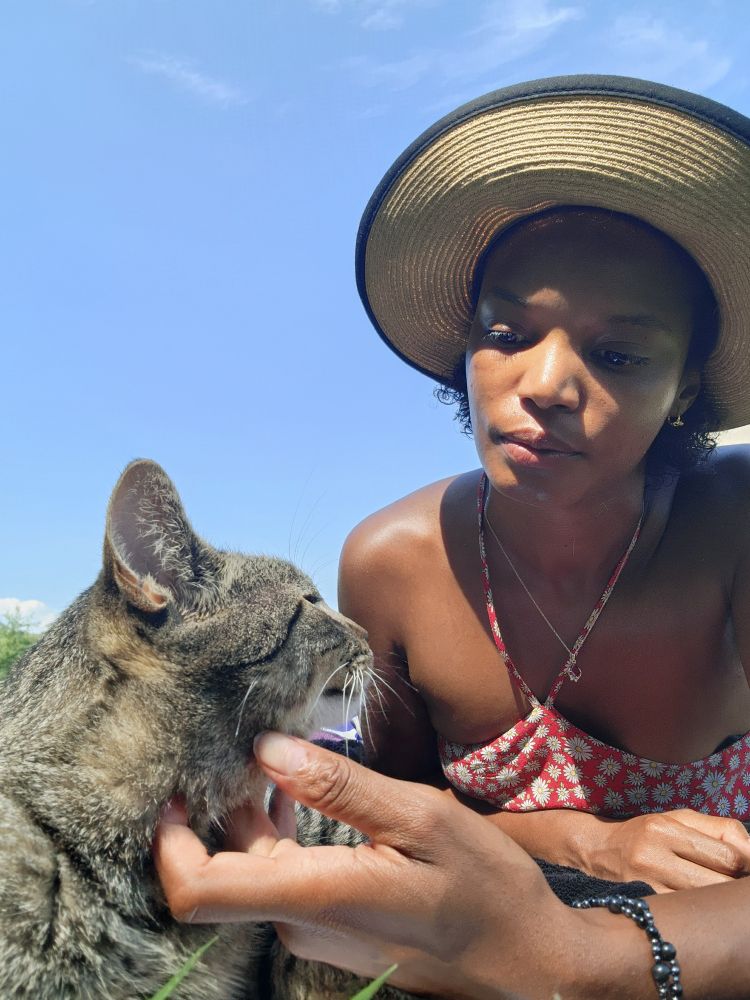 Alanna and cat gaze at each other lovingly 