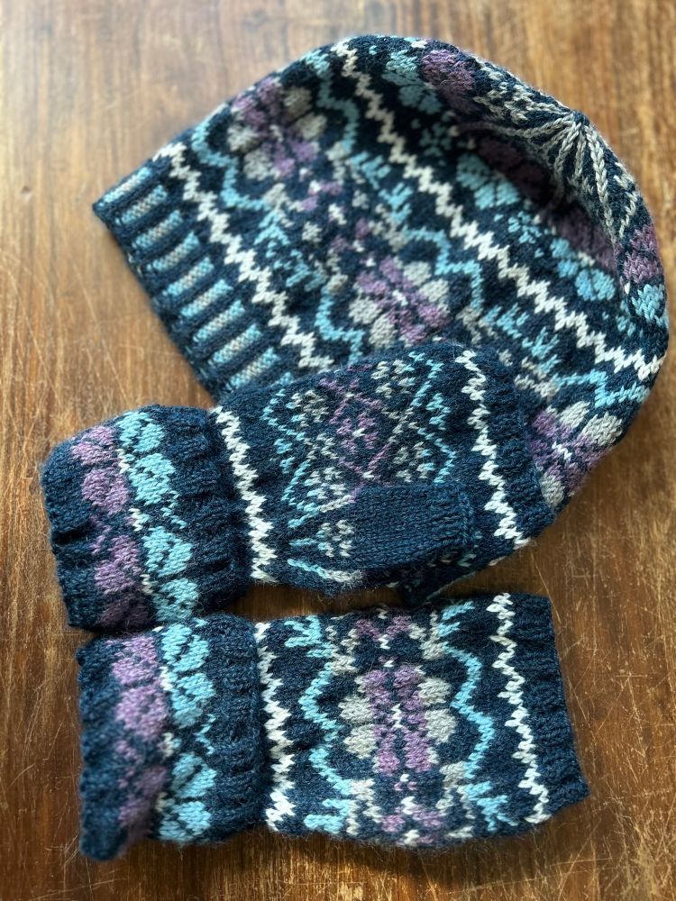 A hat and fingerless mittens set in dark blue with a flower motif. A gift knitted for my sister