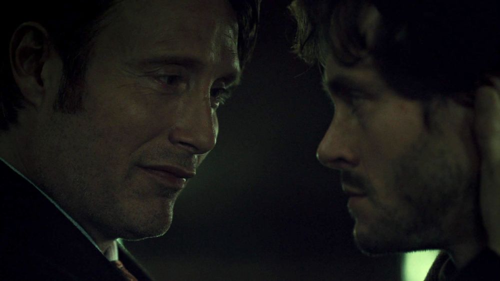 hannibal smiling at will while cradling his head 