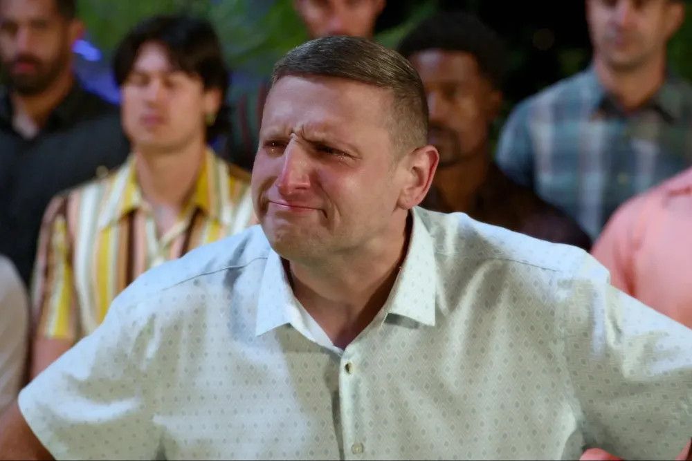 an image of Tim Robinson from the I Think You Should Leave sketch that's poking fun at the Bachelorette, making an exaggerated "I don't think that's true" face and holding back tears after being eliminated because the bachelorette realized he was just on the show to use the zipline to jump into the pool at the villa they're staying at