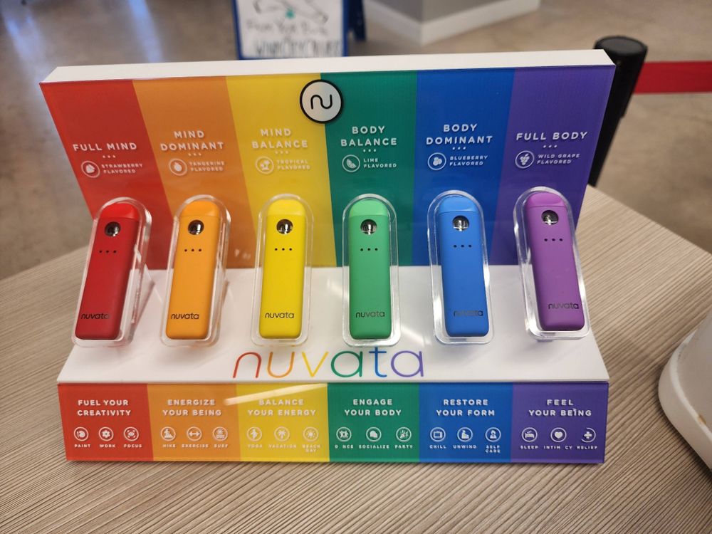 A series of weed vapes arranged side by side, color coded with a rainbow, each labeled from left to right: Full Mind, Mind Dominant, Mind Balance, Body Balance, Body Dominant, Full Body