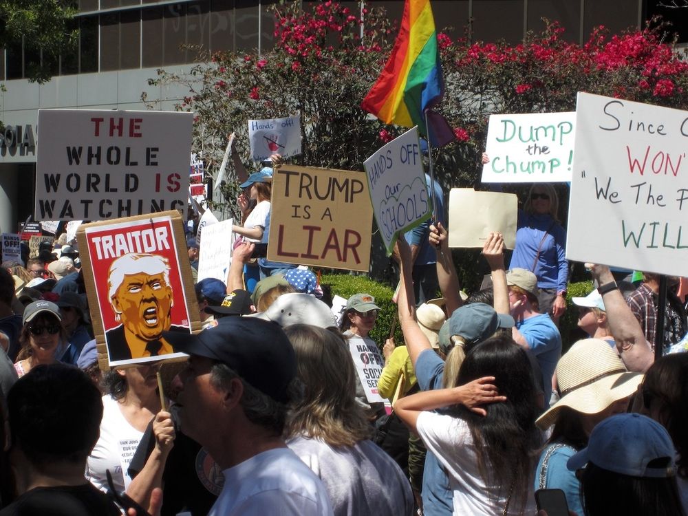 People holding signs at a HandsOff rally in Glendale, California on April 5, 2025.