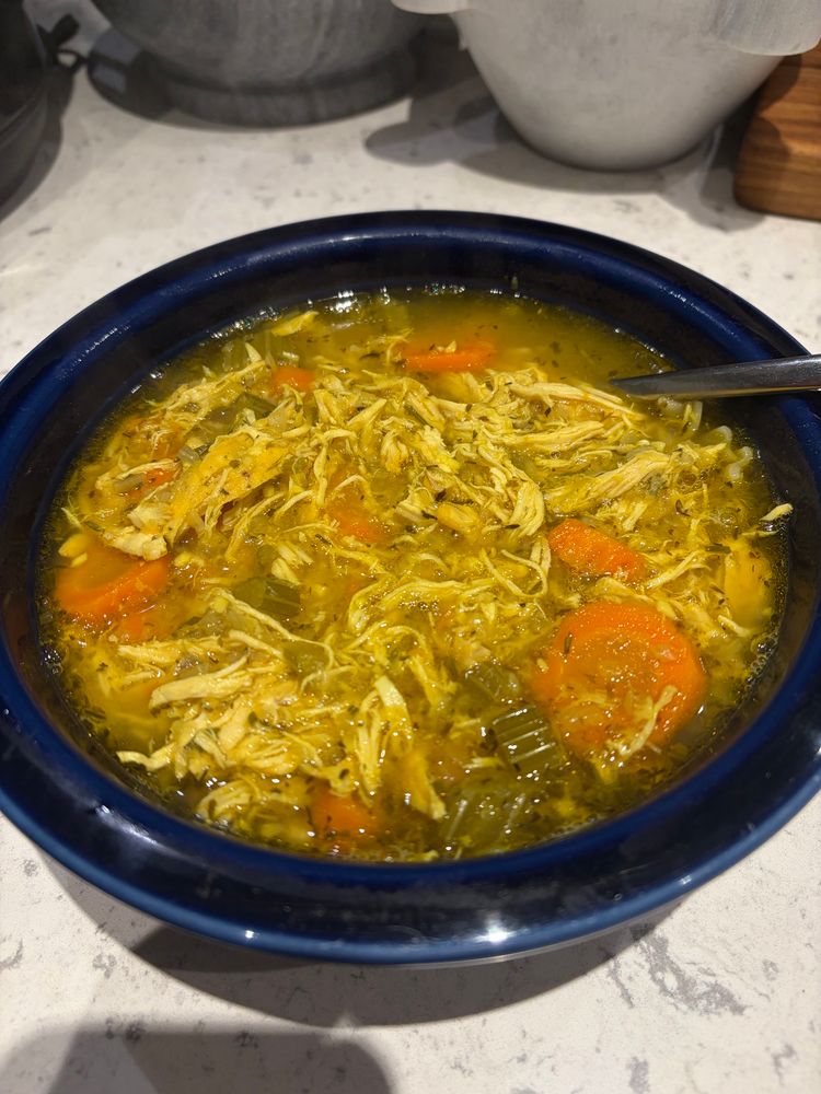 Picture of a bowl of said chicken soup. 

Wolf’s Chicken Soup

Chicken, chicken bone broth, chicken broth concentrate, leeks, thyme, rosemary, garlic, onion, turmeric, tarragon, salt, pepper, carrots, celery, oregano. 