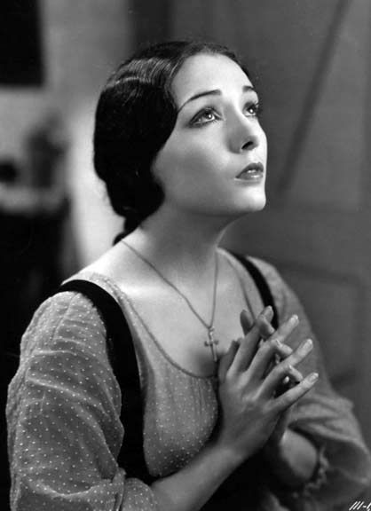 Lupe Velez, wearing a peasant blouse, a chignon, a cross necklace and a devout expression, folds her hands in prayer in RESURRECTION. As I said, I haven't seen the movie, but every still out there seems to be "Lupe praying" or "Lupe swooning in the arms of John Boles." 