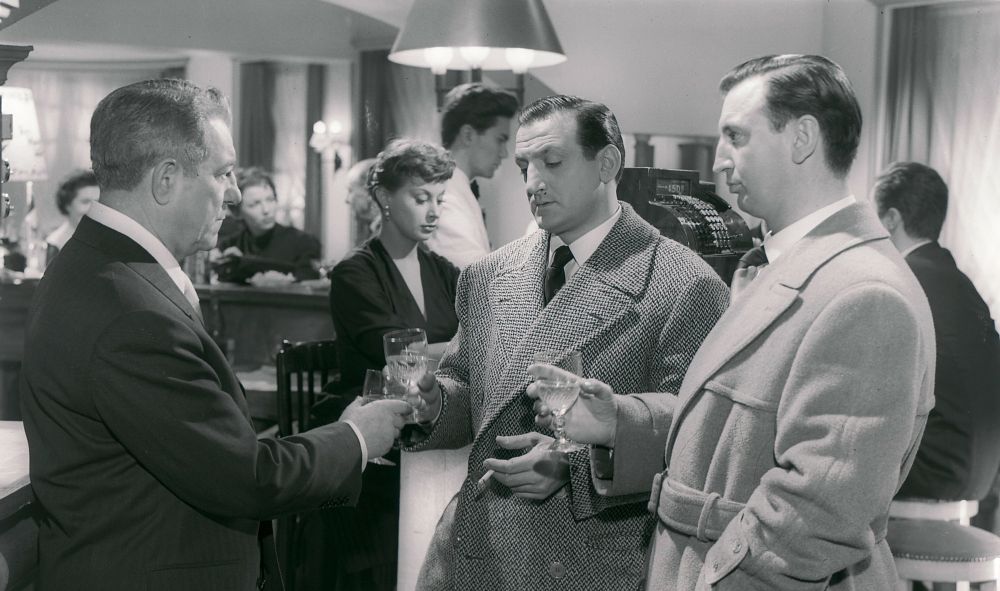 Sharing a toast in the nightclub fronted by Henri "le Nantais" Ferré are Lino Ventura as Roger "le Catalan" (lots of birthplace-based nicknames in this film) and Albert Rémy as, I kid you not, Bibi. Both hitmen have impeccably tailored wool coats. In the background is the exquisite Magali Noel at the club's register; her character is first a cashier but swiftly starts an affair with Henri. 