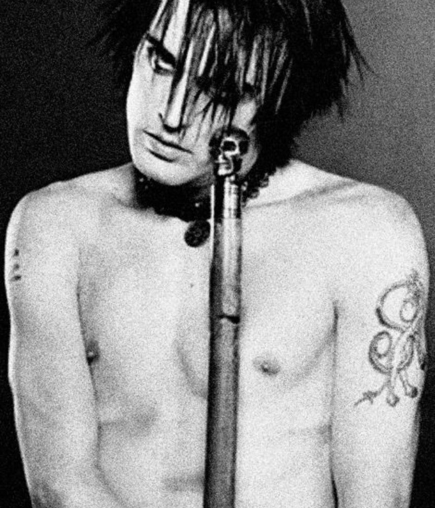 Nivek Ogre holding a cane/stick