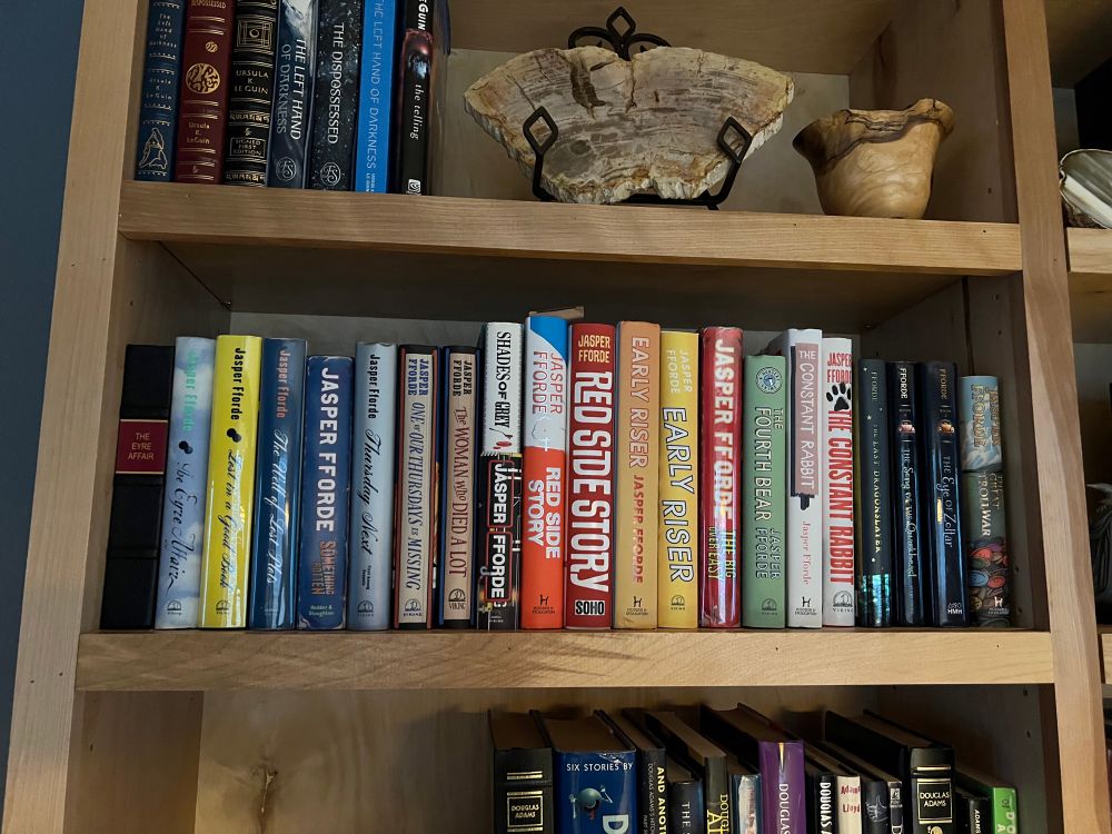 Bookshelf full of Jasper Fforde books. 