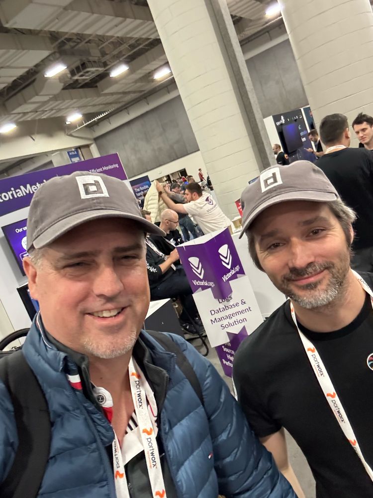 Solomon Hykes and Phil Estes sporting containerd hats 