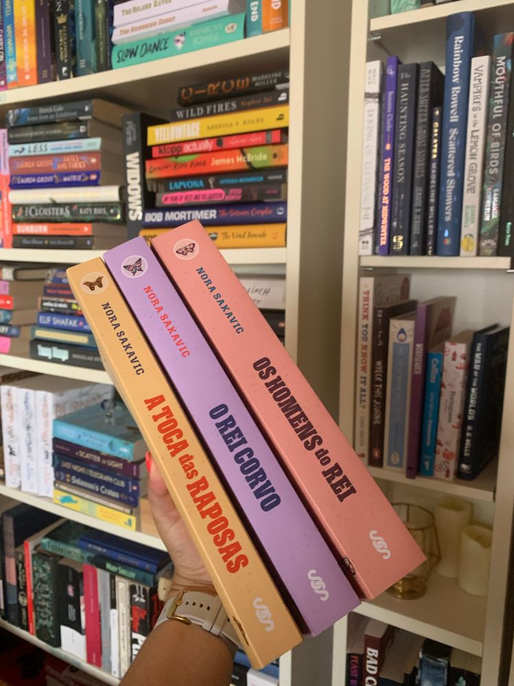 copies of the AFTG trilogy (portuguese translation) being held on front of my ridiculously full bookshelves 