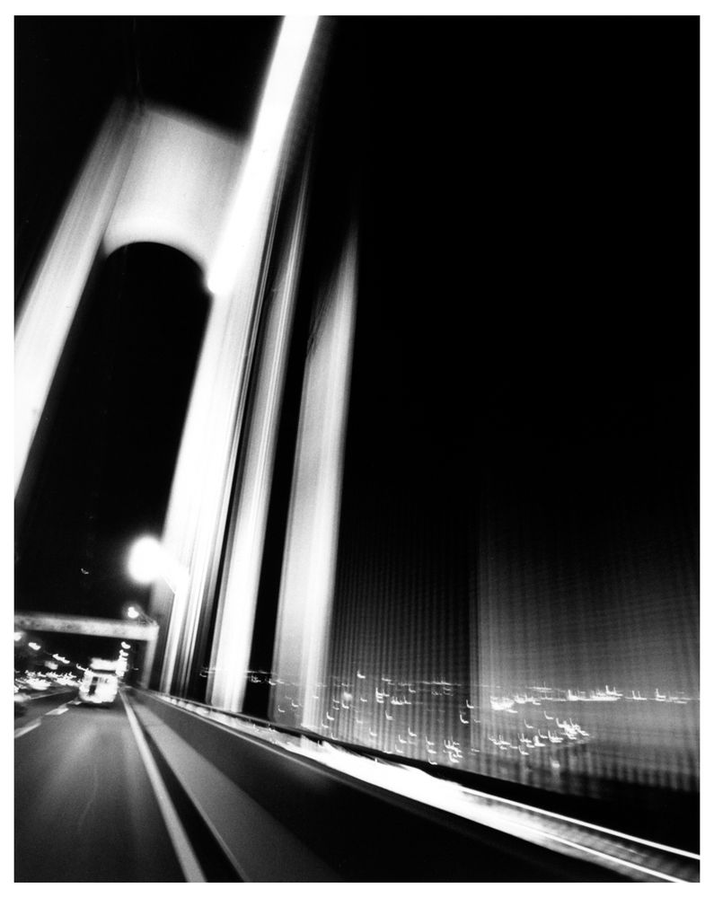 An artistic black and white 35mm photograph of the Verrazano-Narrows bridge in Brooklyn, New York