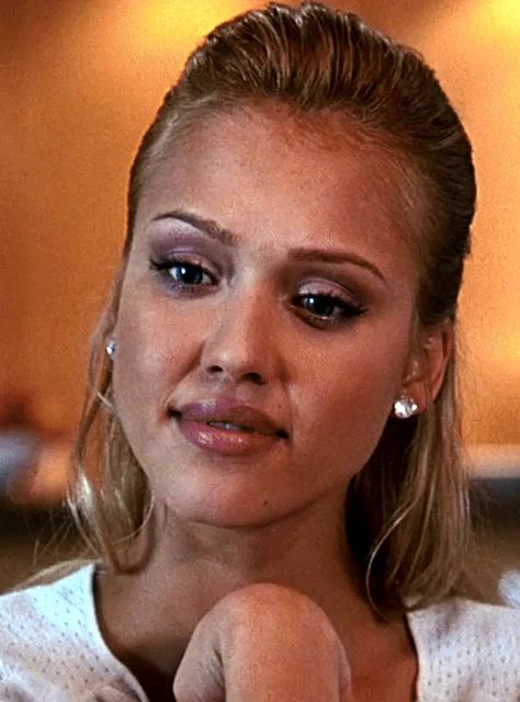 a close up of a woman wearing earrings and a white shirt