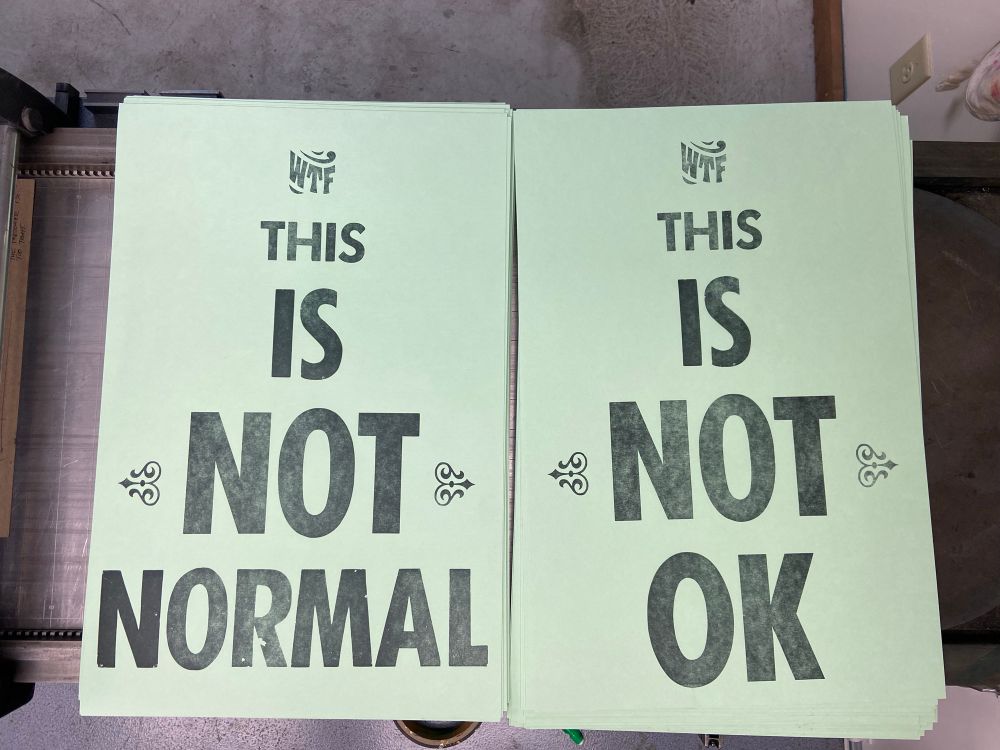 Two letterpress printed posters side by side. one of them reads “WTF THIS IS NOT NORMAL” and the second one says “WTF THIS IS NOT OK”