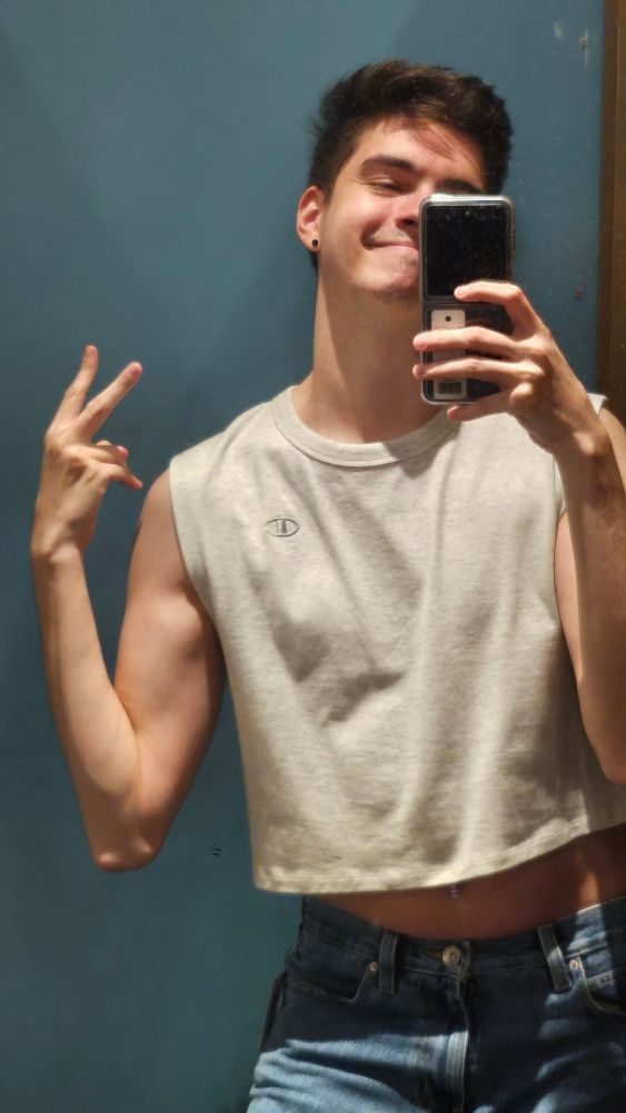 Bisexual twink in a crop top holding a phone with a peace sign??? Girl idk HELP what is this section for