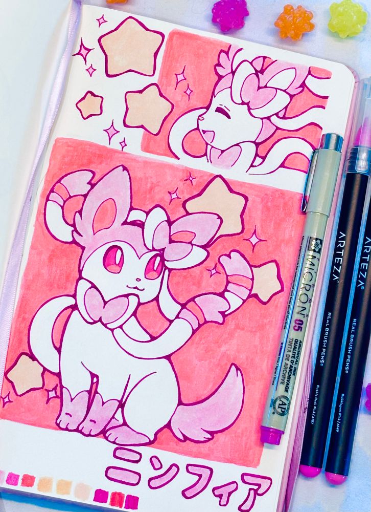 A sketchbook drawing depicting the Pokemon Sylveon, surrounded by stars, with a pink and orange color scheme. 