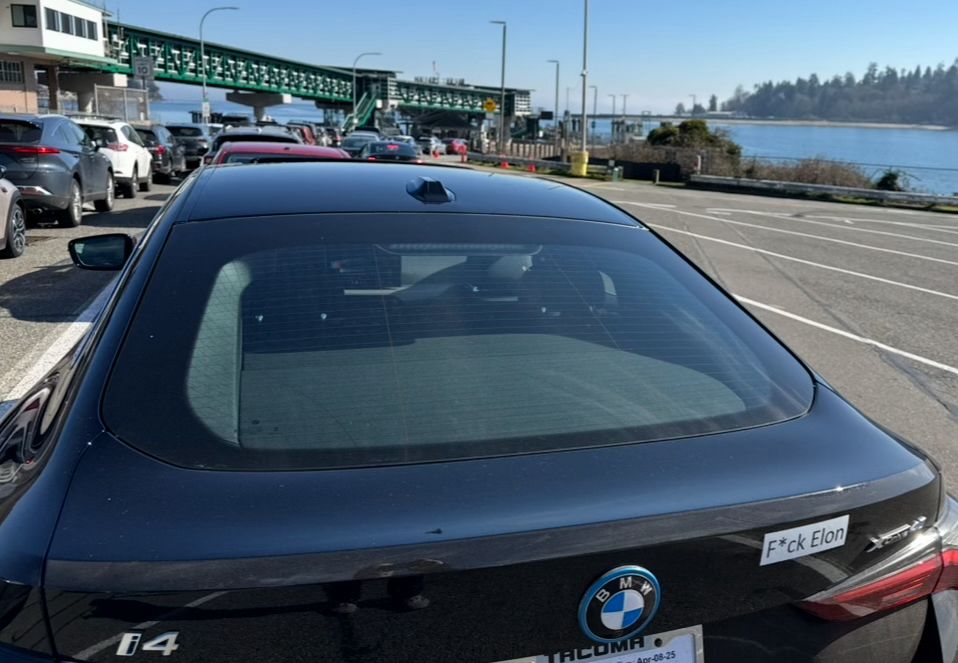 F*ck Elon sticker on the back of an electric BMW