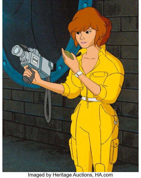 Ace reporter April O'Neil holding a camera with one hand.  The camera probably weighs 70 pounds since this is the 80s, making April O'Neil strong as hell.