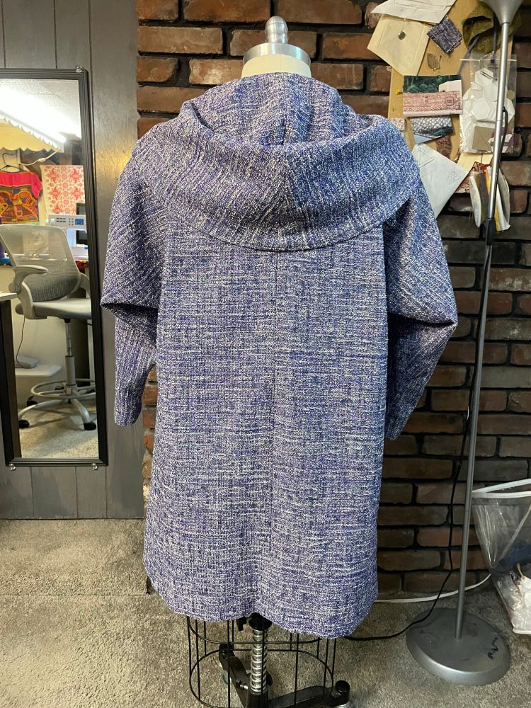 Unlined, knee length coat with convertible collar/hood. 