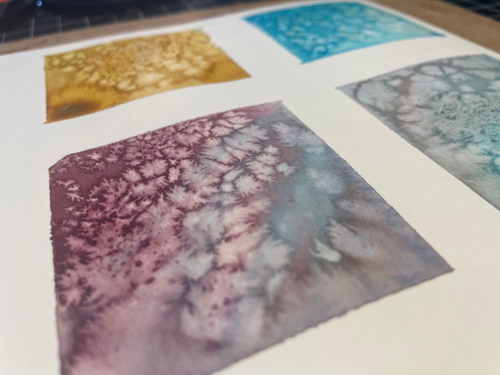 small watercolor paintings with varying colors and splotchy shapes