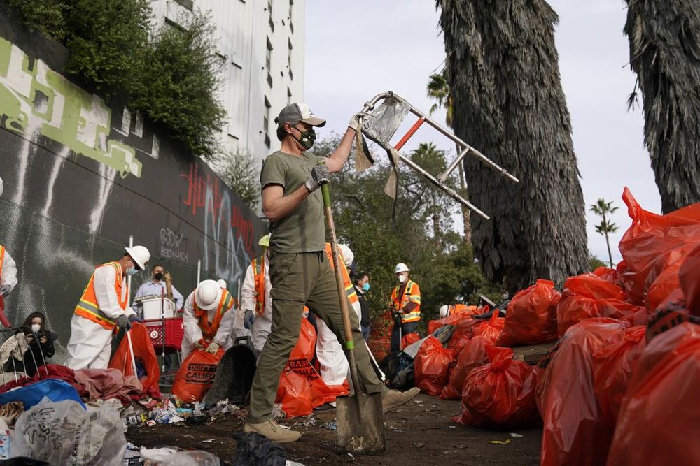 Gavin Newsom holds a decrepit walker he stole from a homeless person.