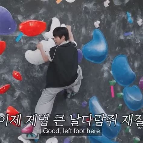 Jin from BTS climbing on an indoor climbing wall in Run Seokjin.  The text says good, left foot here