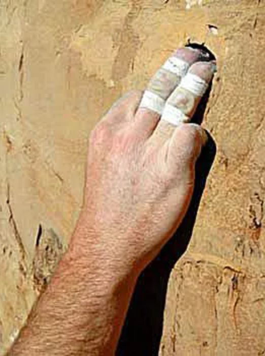 A taped up hand and a two finger pocket