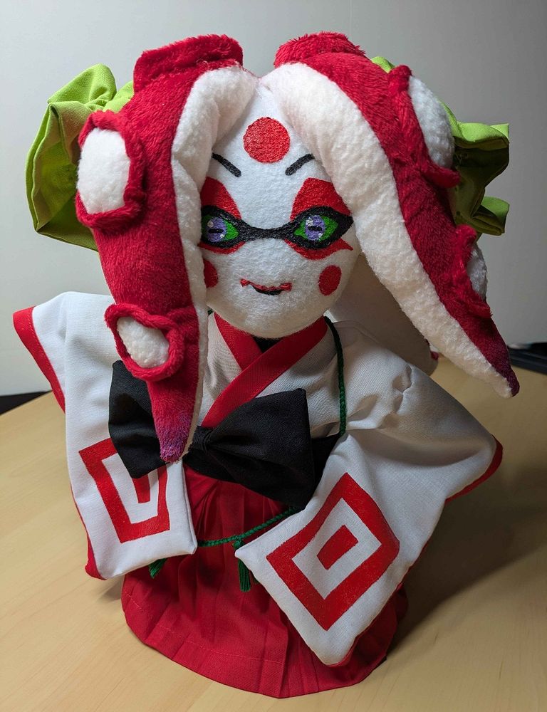 Full body picture of a handmade plushie of a Splatoon oc who happens to be a female Octoling dressed in kabuki inspired attire. She does not have the goggles around her neck in this image. She has been made with a lot of love and care.