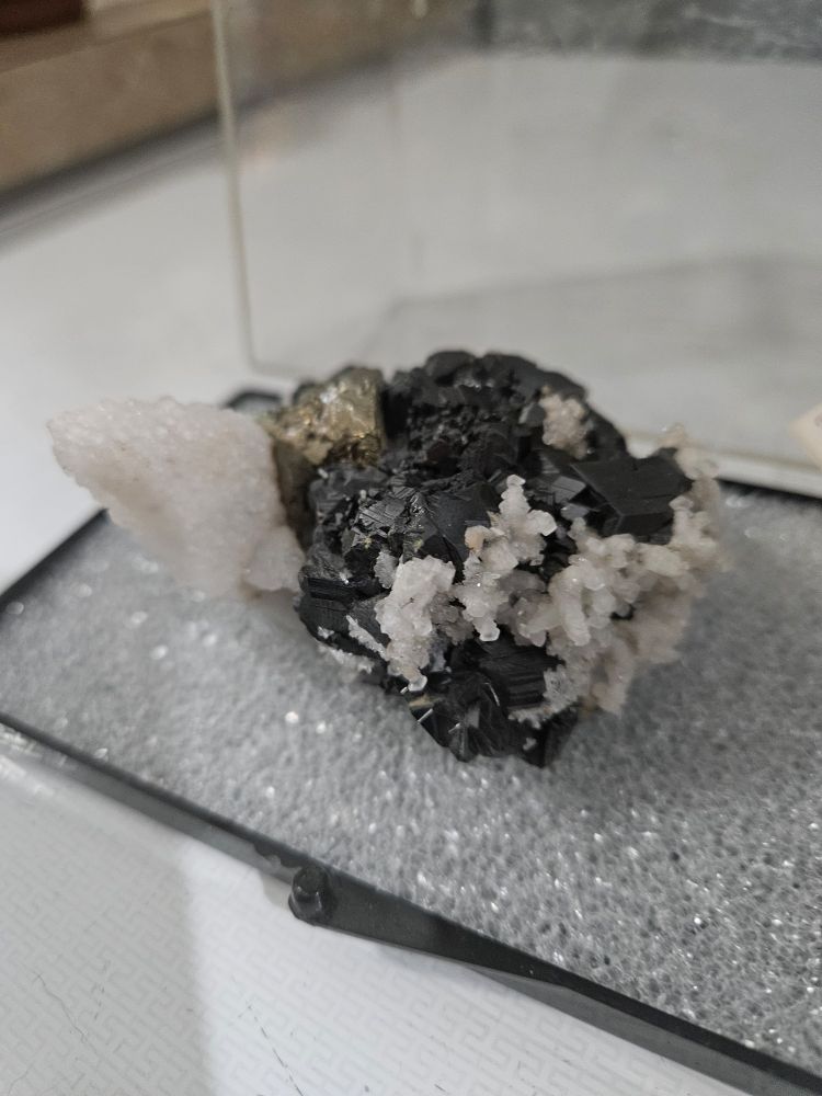 Third view of the same rock. The small calcite crystals are in the front, attached to the sphalerite. The chalcopyrite and big calcite crystal are in the back. 