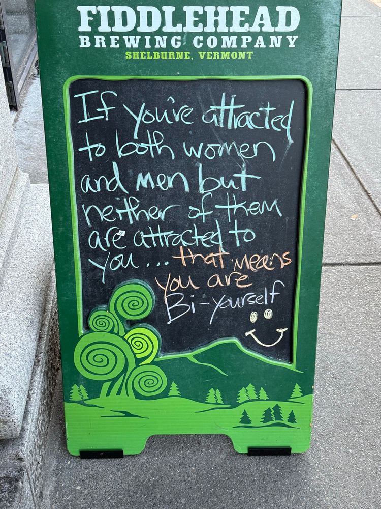 A sign that says “if you’re attracted to both men and women but neither of them are attracted to you…that means you are bi-yourself 🙂” in three different colors or chalk
