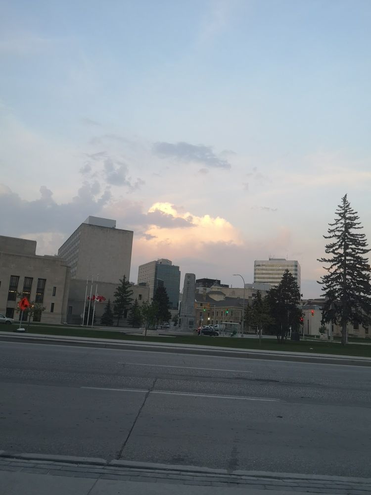 A view of the Winnipeg skyline downtown. The clouds in the sunset are pretty.