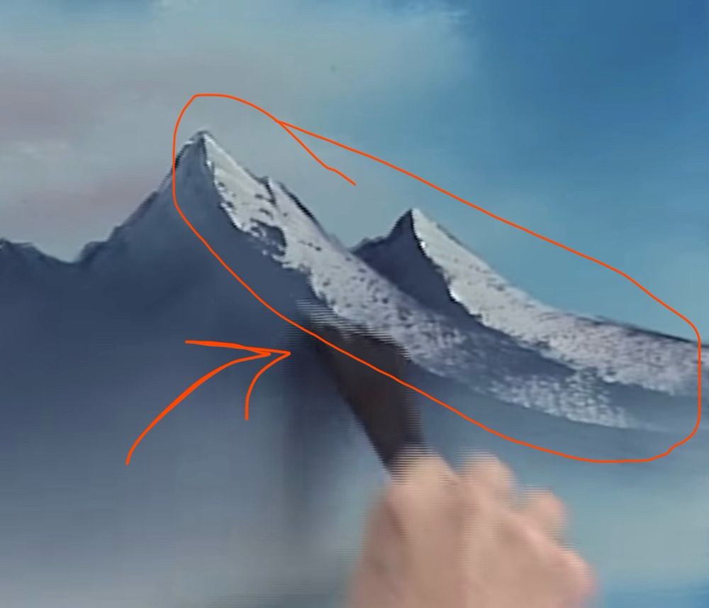 Bob Ross using a palette knife with white oil paint to create a rough texture on the side of a mountain painting on canvas