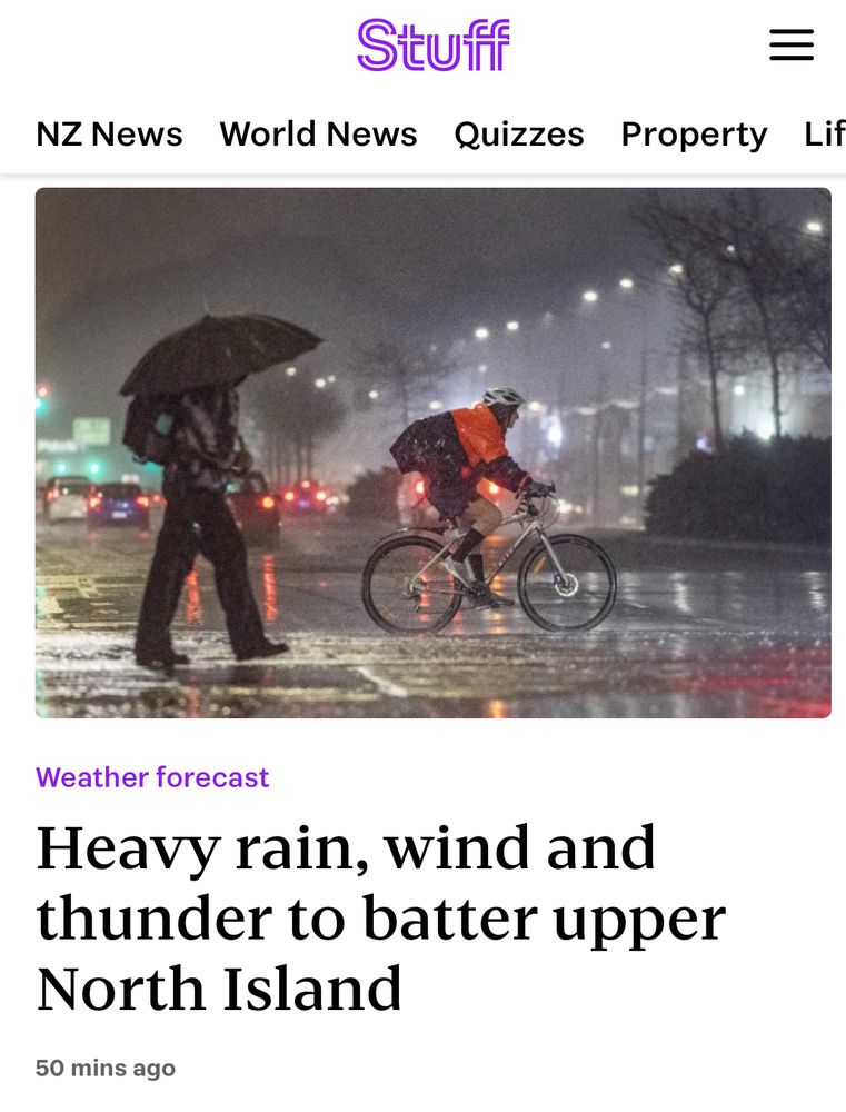 A classic of the genre from Stuff NZ: headline says “Heavy rain, wind and thunder to batter upper North Island”, and the photo shows a person on a bike and a pedestrian, both proceeding sturdily along a wet dark city street because actually we won’t melt. 